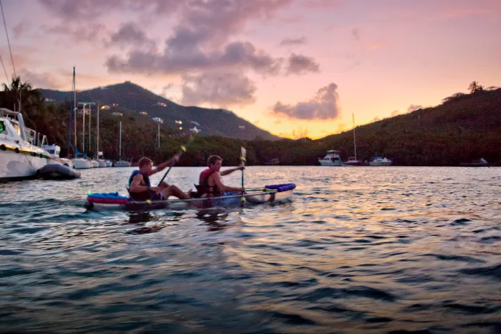 two clients paddling in the sunset of St. Criox