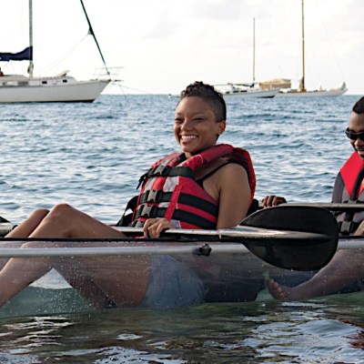 customers in clear kayaks during the day