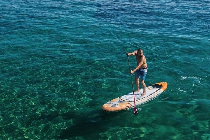 a person riding a surf board on a body of water