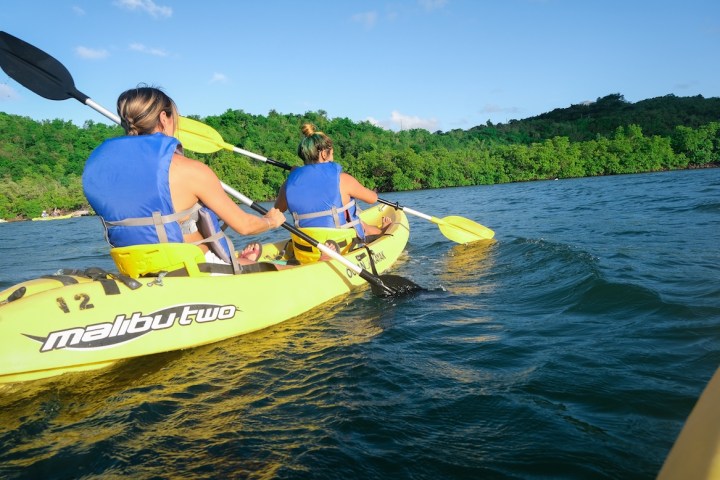 a person riding a surf board on a body of water