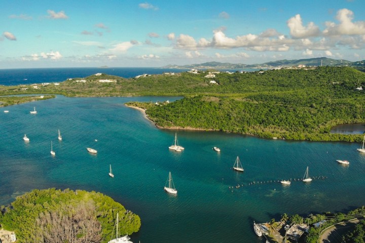 a large body of water with a mountain in the background